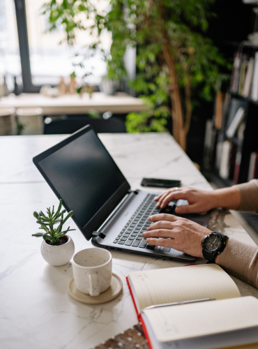 Small business owner working on laptop to set up bookkeeping and accounting software