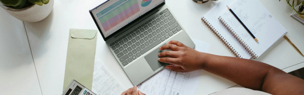 Small business owner setting up accounting software on laptop for bookkeeping and financial record organisation