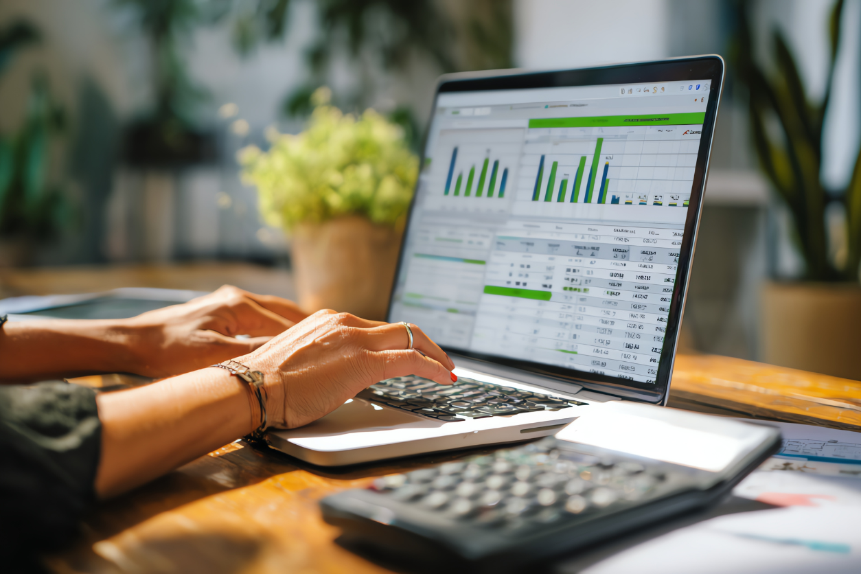 Setting up small business accounting software on a laptop with financial dashboard and calculator